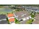An aerial view showcases townhomes near a scenic lake and lush landscaping at 7400 Estuary Lake Loop, Celebration, FL 34747