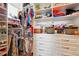 Walk-in closet with ample storage, including shelves, drawers, and hanging rods for clothes and accessories at 7400 Estuary Lake Loop, Celebration, FL 34747