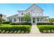 Charming two-story home with a covered porch and professionally landscaped front yard at 7400 Estuary Lake Loop, Celebration, FL 34747