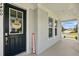 Welcoming front door with seasonal decorations and a covered porch at 7400 Estuary Lake Loop, Celebration, FL 34747