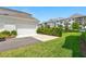 Exterior view featuring a two-car garage and well-maintained landscaping at 7400 Estuary Lake Loop, Celebration, FL 34747