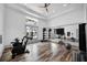 Bright gym with workout bikes, fitness equipment, large mirror, and wood floor at 7400 Estuary Lake Loop, Celebration, FL 34747