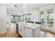 Open kitchen offers stainless appliances, granite counters, an island with bar seating, and views of the living space at 7400 Estuary Lake Loop, Celebration, FL 34747