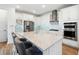 Bright kitchen features a center island with bar stool seating, white cabinetry, stainless appliances, and stylish backsplash at 7400 Estuary Lake Loop, Celebration, FL 34747