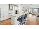 Bright open concept kitchen with an island and bar seating, stainless steel appliances, and views of the living room at 7400 Estuary Lake Loop, Celebration, FL 34747