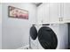 Modern laundry room equipped with front load washer and dryer at 7400 Estuary Lake Loop, Celebration, FL 34747