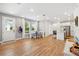 Open-concept living area with lots of natural light, hardwood floors, dining table, and stainless steel appliances at 7400 Estuary Lake Loop, Celebration, FL 34747