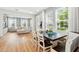 Open-concept living area with lots of natural light, hardwood floors, dining table, and comfortable sectional couch at 7400 Estuary Lake Loop, Celebration, FL 34747