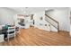 Bright, open-concept living room with modern flooring, dining area, and kitchen featuring stainless steel appliances at 7400 Estuary Lake Loop, Celebration, FL 34747