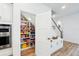 Walk-in pantry includes built-in shelving and ample storage for food and other household items at 7400 Estuary Lake Loop, Celebration, FL 34747