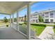 Serene view from a covered porch overlooking a manicured lawn and community streetscape at 7400 Estuary Lake Loop, Celebration, FL 34747