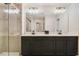 Modern bathroom with a double vanity, sleek fixtures, and a tiled walk-in shower at 8042 Glenlloyd Ave, Winter Garden, FL 34787