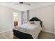 Comfortable bedroom with a polka-dot comforter, a dark upholstered headboard, and views of a stylish ensuite bathroom at 8042 Glenlloyd Ave, Winter Garden, FL 34787