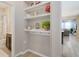 Stylish entryway with built-in shelving and hooks, leading into an open-concept living space at 8042 Glenlloyd Ave, Winter Garden, FL 34787