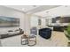 Open-concept living area with modern furnishings, light wood floors, and plenty of natural light at 8042 Glenlloyd Ave, Winter Garden, FL 34787