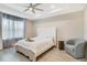 Elegant main bedroom with a luxurious bed, ceiling fan, and a serene atmosphere for relaxation at 8042 Glenlloyd Ave, Winter Garden, FL 34787
