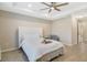 Spacious main bedroom with a stylish bed, tray ceiling, and ample natural light from windows at 8042 Glenlloyd Ave, Winter Garden, FL 34787