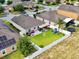 Aerial view of the home showcasing the backyard, patio, playground, and landscaping at 810 Jefferson Blvd, Haines City, FL 33844