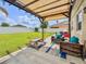 Backyard patio area with covered pergola, seating, and a well-maintained lawn at 810 Jefferson Blvd, Haines City, FL 33844