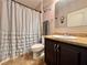 Cozy bathroom with vanity, sink, mirror, and a shower with a white ruffled curtain at 810 Jefferson Blvd, Haines City, FL 33844