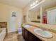 Bathroom featuring a double sink vanity, decorative accents and tile flooring at 810 Jefferson Blvd, Haines City, FL 33844