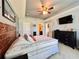 Comfortable bedroom features a ceiling fan, wooden headboard, and ensuite bathroom access at 810 Jefferson Blvd, Haines City, FL 33844