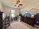 Cozy bedroom with mountain mural, ceiling fan, and dark wood furnishings, creating a serene space at 810 Jefferson Blvd, Haines City, FL 33844