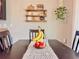 Warm dining area with fruit centerpiece, floating shelves, and a cozy ambiance for enjoyable meals at 810 Jefferson Blvd, Haines City, FL 33844