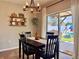 Dining area with dark wood table, backyard view, and rustic chandelier, perfect for Gathering meals at 810 Jefferson Blvd, Haines City, FL 33844