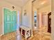 Bright foyer with colorful front door, tile flooring, and hallway leading to additional rooms at 810 Jefferson Blvd, Haines City, FL 33844