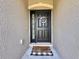 Close-up of the front door with decorative wreath and a 'There's no place like home' door mat at 810 Jefferson Blvd, Haines City, FL 33844