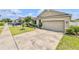 Attractive single-story home featuring a 2-car garage, landscaped front yard with stone edging, and lush green grass at 810 Jefferson Blvd, Haines City, FL 33844