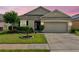 Charming single-story home with a well-manicured lawn, beautiful landscaping, and a two-car garage at 810 Jefferson Blvd, Haines City, FL 33844