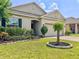 Charming home featuring a well-maintained lawn with landscaped garden beds and a two-car garage at 810 Jefferson Blvd, Haines City, FL 33844