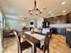 Open-concept kitchen and dining area with granite countertops, dark cabinets, and a seamless flow at 810 Jefferson Blvd, Haines City, FL 33844