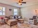 Comfortable living room featuring plush sofa, accent chair, and neutral tones for a cozy atmosphere at 810 Jefferson Blvd, Haines City, FL 33844