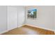 Cozy bedroom featuring wood floors, a window with a view, and a closet at 818 Ballard St, Altamonte Springs, FL 32701