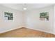 Bedroom featuring two windows, wood floors, and a ceiling fan at 818 Ballard St, Altamonte Springs, FL 32701