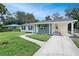 Charming home with a well-manicured front yard, carport, and a freshly painted exterior at 818 Ballard St, Altamonte Springs, FL 32701