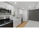Modern kitchen featuring stainless steel appliances, granite countertops, and white cabinetry at 818 Ballard St, Altamonte Springs, FL 32701