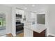 Modern kitchen featuring white cabinetry, stainless steel appliances, and a center island at 818 Ballard St, Altamonte Springs, FL 32701