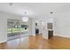 Open living space with hardwood floors, screened-in porch, and an island with a breakfast bar at 818 Ballard St, Altamonte Springs, FL 32701