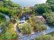 Aerial view of lakefront property with private beach, boat dock and wooded privacy at 822 S Breen Rd, Lake Wales, FL 33898