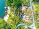 Aerial view of lakefront lot highlighting home, detached garage, beach and lake access at 822 S Breen Rd, Lake Wales, FL 33898