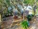 Backyard featuring a screened-in porch and wooden deck overlooking the spacious landscaped yard at 822 S Breen Rd, Lake Wales, FL 33898