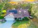 Charming single-Gathering home featuring solar panels, dormer windows, a well-manicured lawn, and two car garage at 822 S Breen Rd, Lake Wales, FL 33898