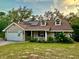 Inviting home featuring a cozy front porch, a well-kept lawn, and sustainable solar panels for energy efficiency at 822 S Breen Rd, Lake Wales, FL 33898
