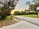 Street view featuring unique mailbox, manicured lawn and established landscaping at 822 S Breen Rd, Lake Wales, FL 33898