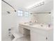 Bright bathroom featuring double sink, neutral paint and tiled tub at 8310 Happy Trails, Kissimmee, FL 34747
