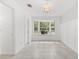 Bright bedroom featuring tile floors, modern wainscoting and a window seat with a view to a landscaped yard at 8310 Happy Trails, Kissimmee, FL 34747